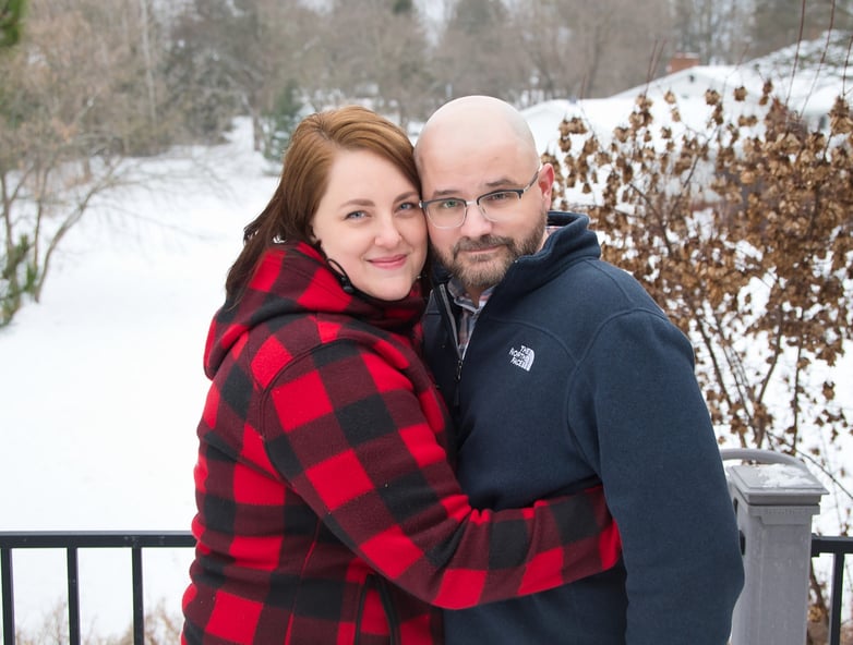 a man and woman standing in the snow