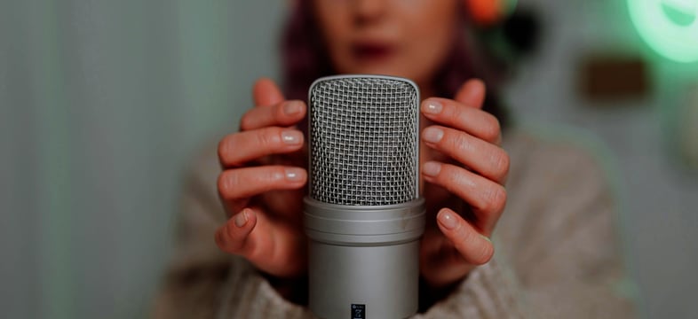 a woman holding a microphone in front of her