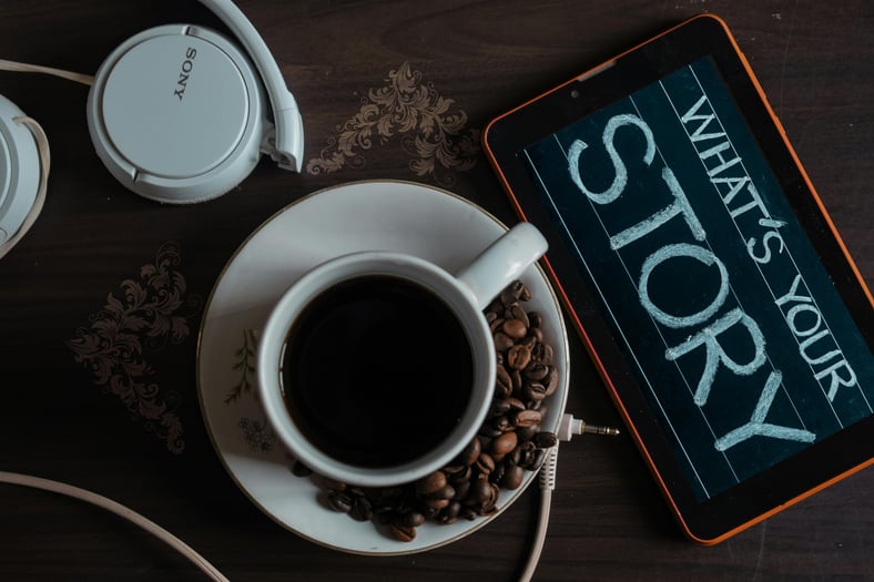 a tablet with a cup of coffee and headphones