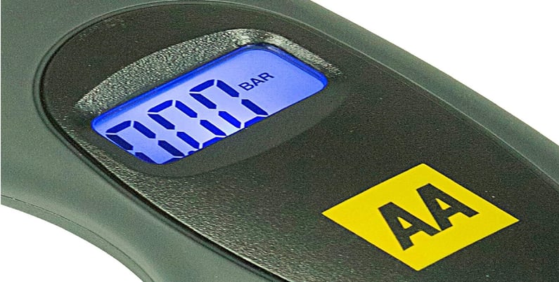 AA Digital Tyre Pressure Gauge AA1634 in use, checking tyre pressure with its backlit LCD screen and ergonomic handle