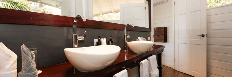a bathroom with a large mirror and a sink