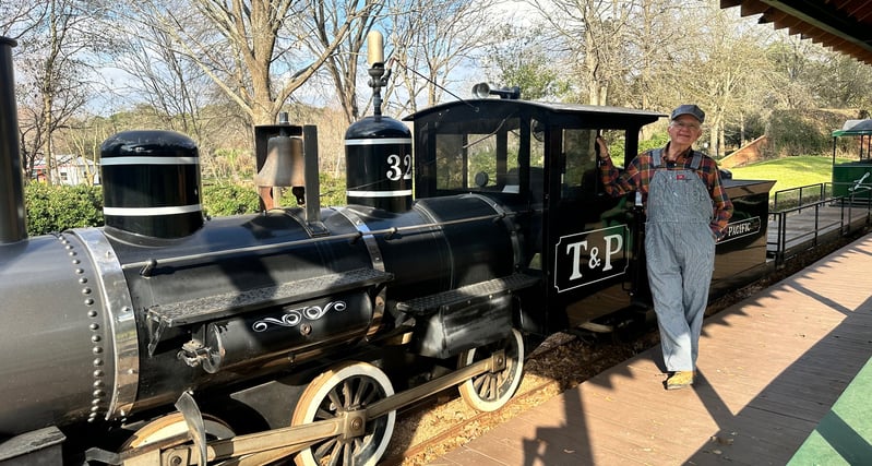 a man standing next to a train