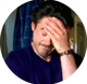 A man placing his hand to his head, displaying frustration.