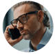 Headshot of a man wearing glasses on a mobile phone.