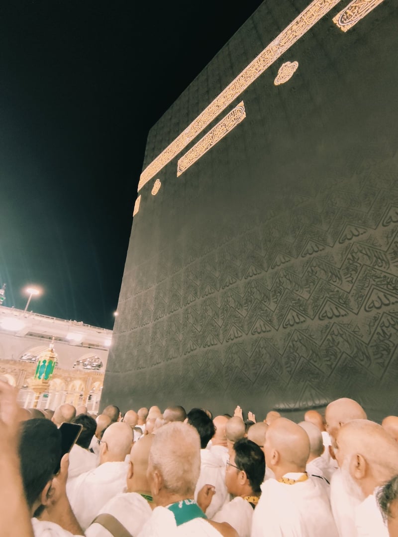 Close-up of Ka'bah kiswah with gold calligraphy at night