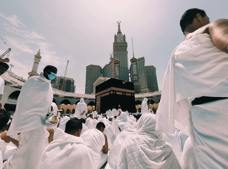 Pilgrims performing tawaf around Ka'bah with Abraj Al-Bait backdrop