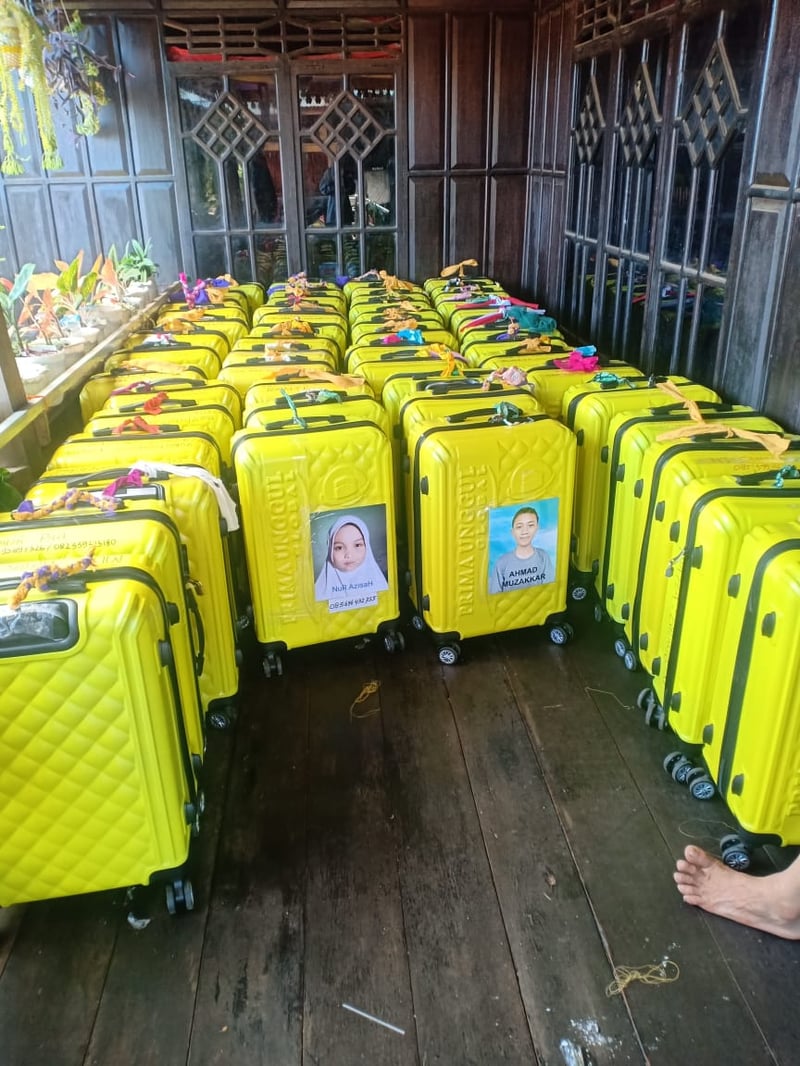 Neatly arranged yellow suitcases of Prima Unggul Global pilgrims
