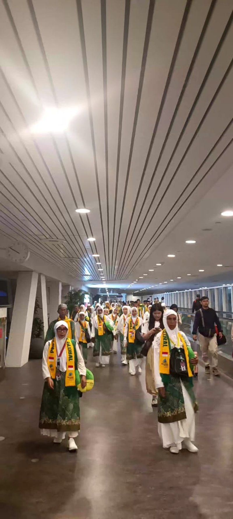 Pilgrims walking through airport corridor