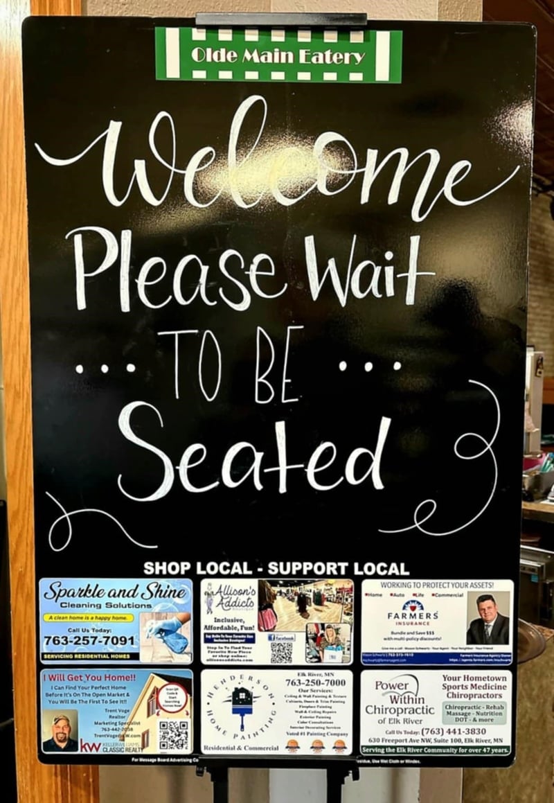 Welcome Please Wait to Be Seated board at Olde Main Eatery