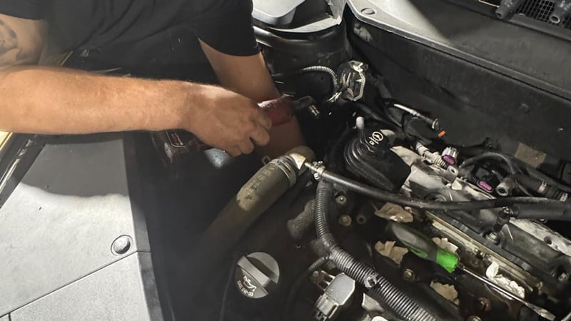 Adams Concierge Auto technician performing engine tune-up service in Wesley Chapel, FL