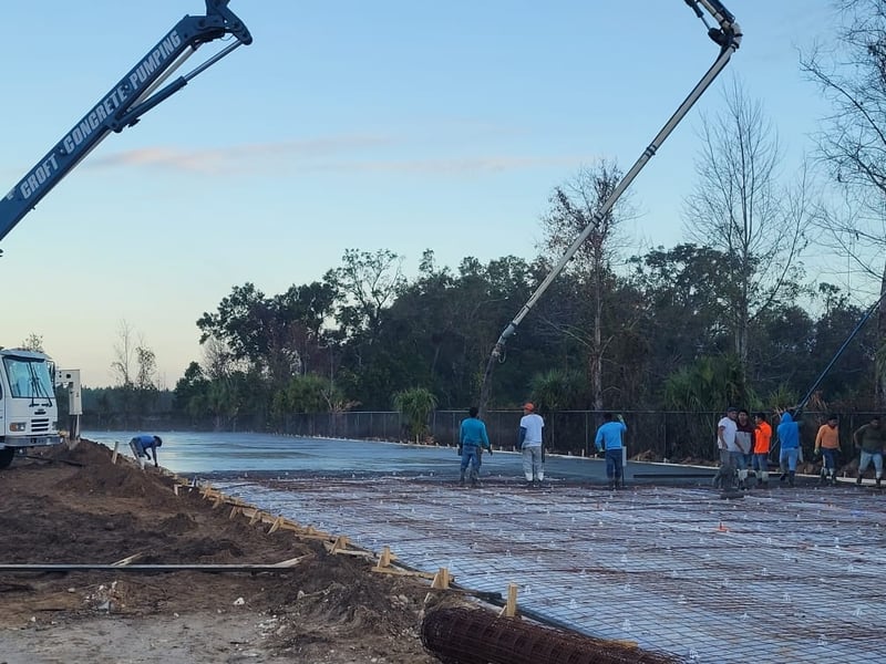 Croft Concrete boom pump extended on active commercial construction site in North Florida