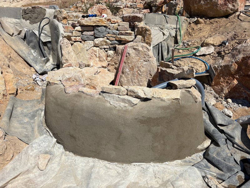 Stone infinity edge and wetland filtration zone — Lisbon Natural Pool Oasis