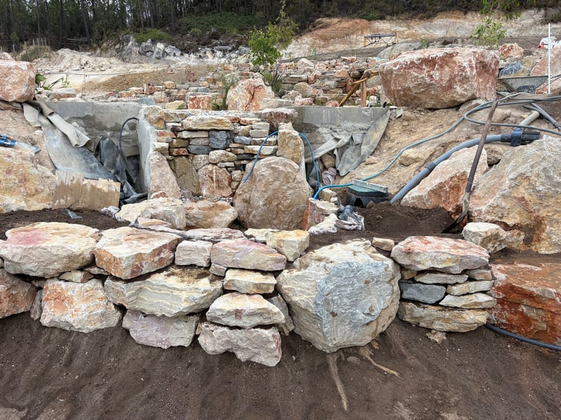 Natural pool with stone steps and timber railing — Lisbon, Portugal