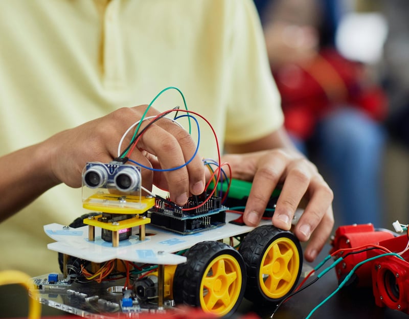 a kid is holding a remote control car