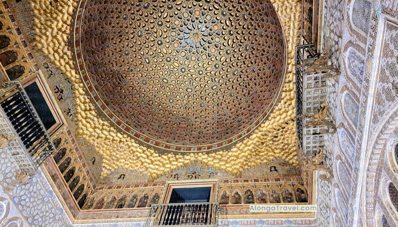 A huge golden dome in Alcazar de Real covered with intricate wood & metal colorful details