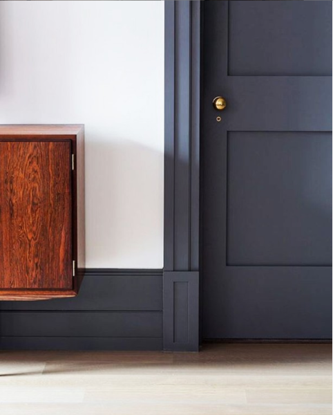 navy blue bedroom door with gold hardware 