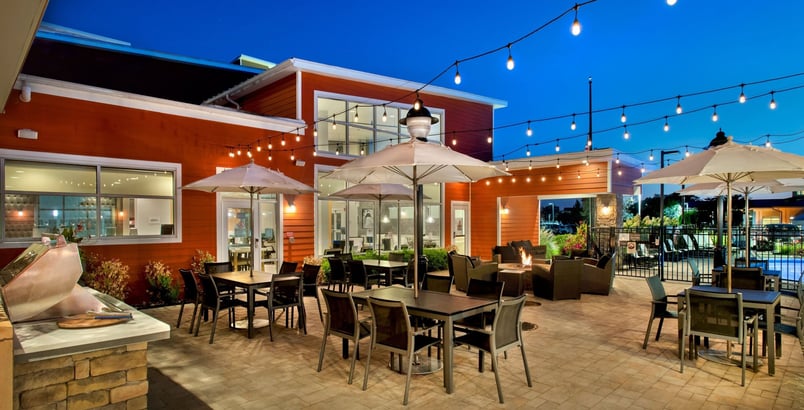 a patio with tables and umbrellas