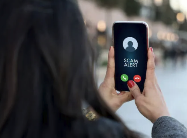 a woman holding a cell phone with a scammy scammy scam