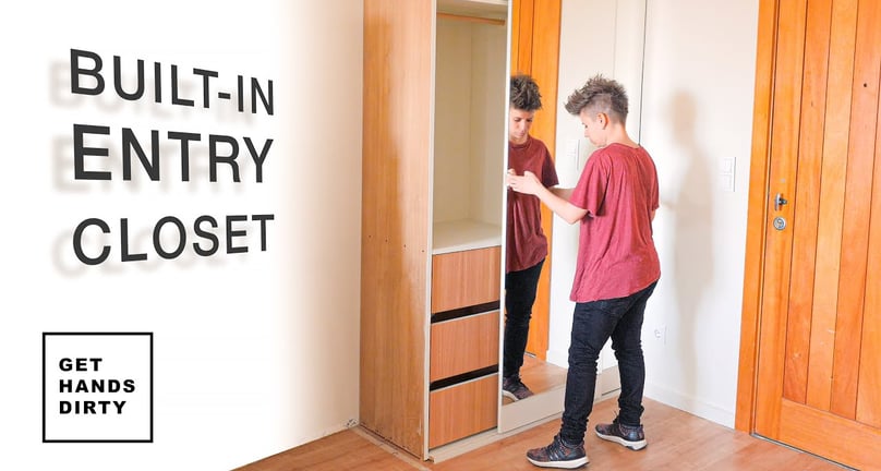 You can see a closet with sliding mirror doors by the entrance door at the hall of an apartment.