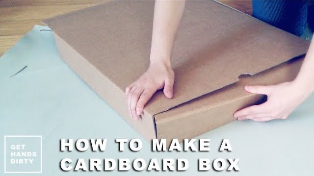 Hands assembling a handmade easy cardboard box