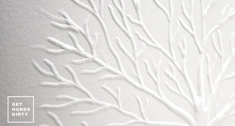 A tree illustration embossed in white thick cotton paper