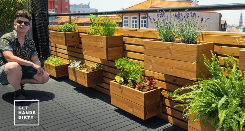 Balcony with waterproofed wood planters organized in modules to create a vertical garden