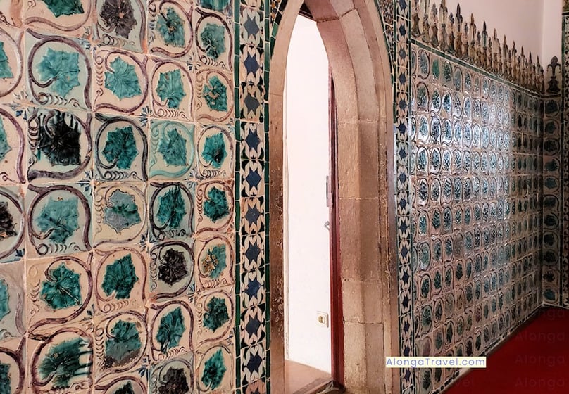 A narrow oval door surrounded by colorful Moorish tiles in National Palace of Sintra