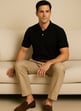 a man sitting on a couch with his feet up