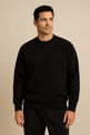 a man in a black sweater and pants