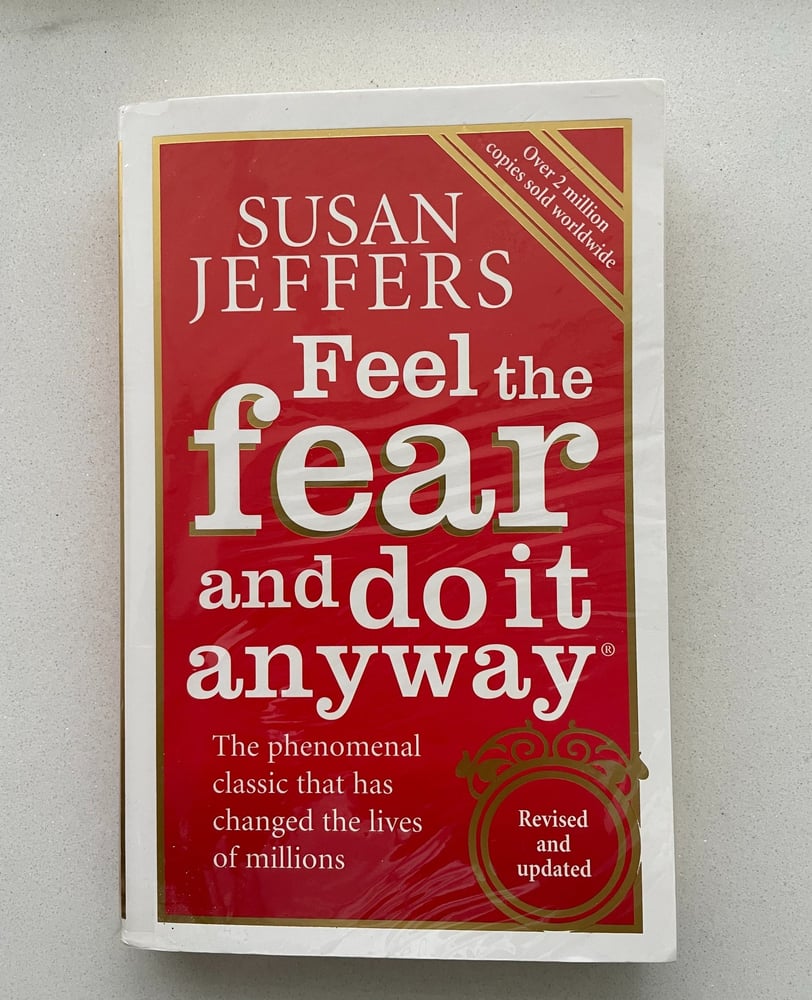 a book cover of a book with a red cover Feel the fear and do it anyway