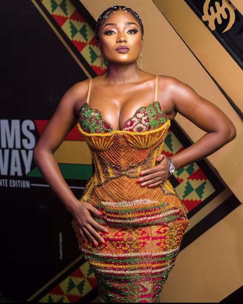 Efya Nocturnal in an African print dress.