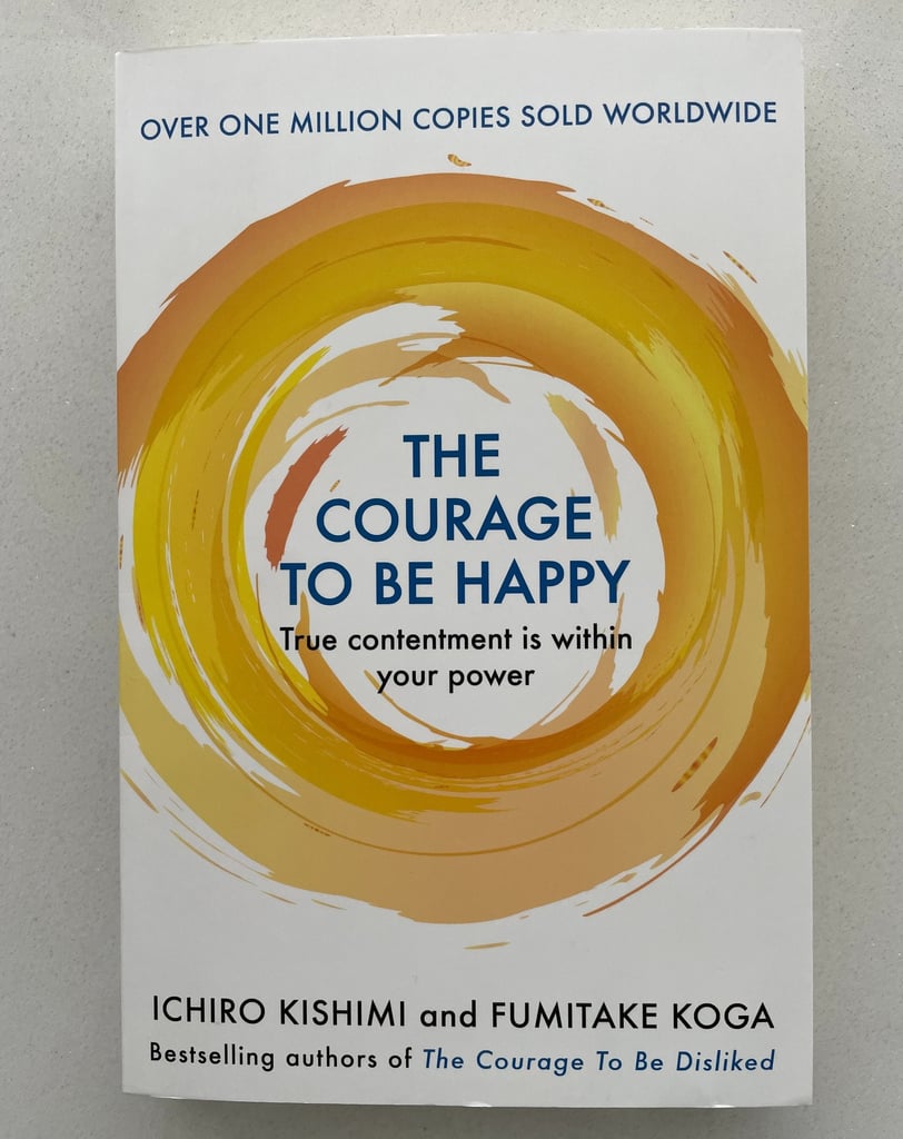 a book cover of the book the courage to be happy