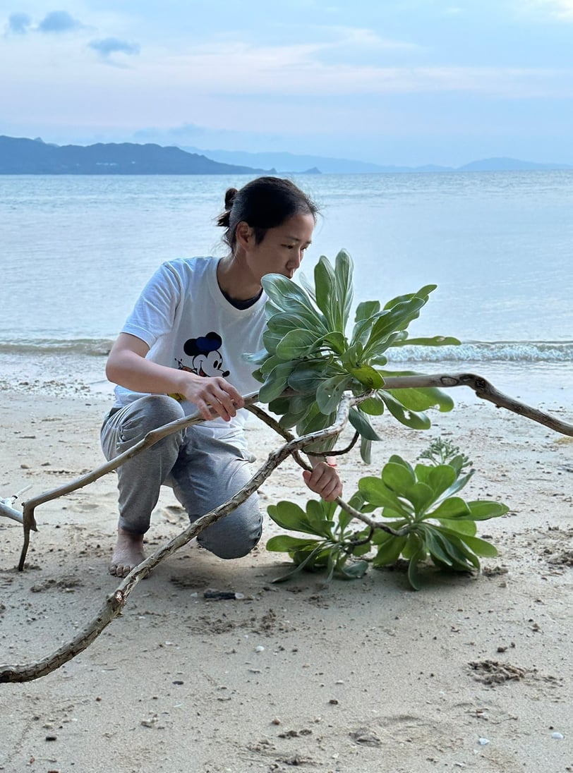 Ikebana performance featuring medicinal herbs and nocturnal pollination elements