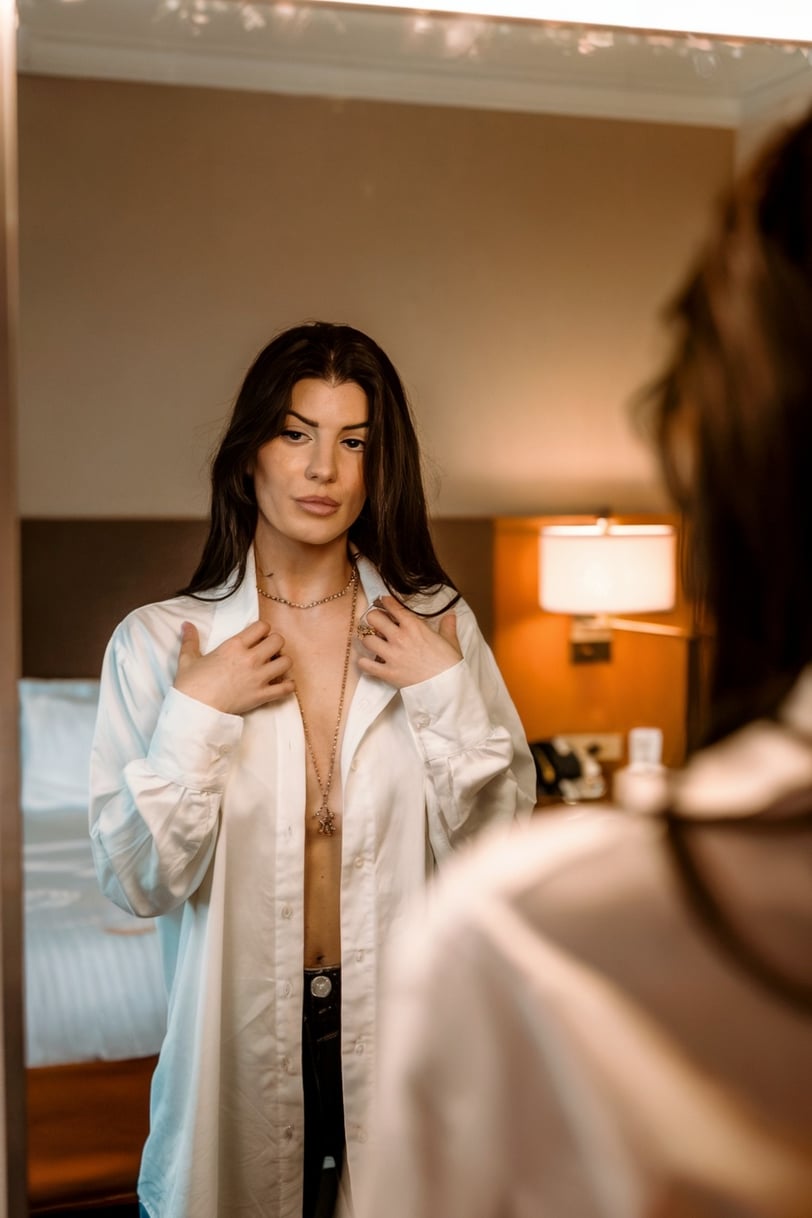 a woman in a white shirt and black pants