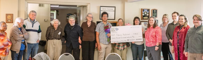 Everyone who was awarded a grant posing for a photo with a large check