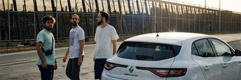 a film crew standing around a car on location