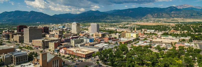 A Colorado Springs skyline view with the Rocky Mountains in the background