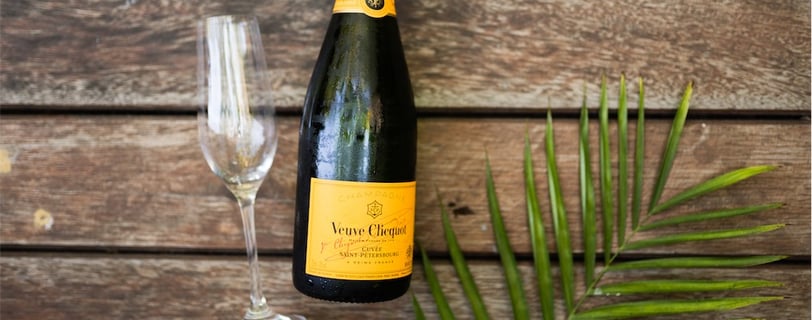 a bottle of champagne in front of a wooden table