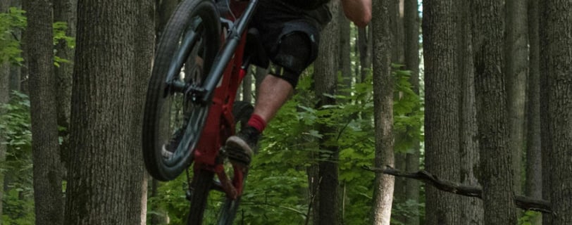 a person jumping a bike over a hill