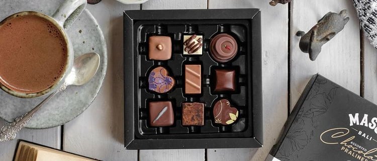 a box of chocolates and a cup of coffee