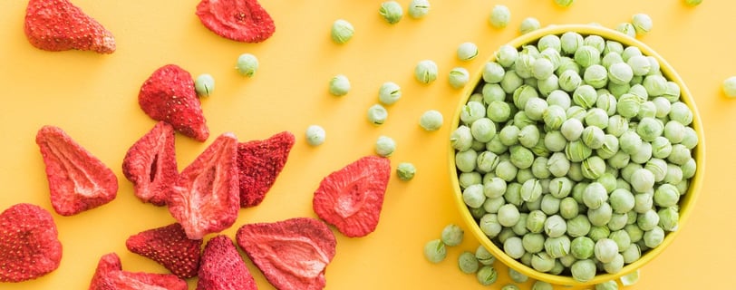 thrive life freeze dried strawberries and green peas on a vibrant yellow background