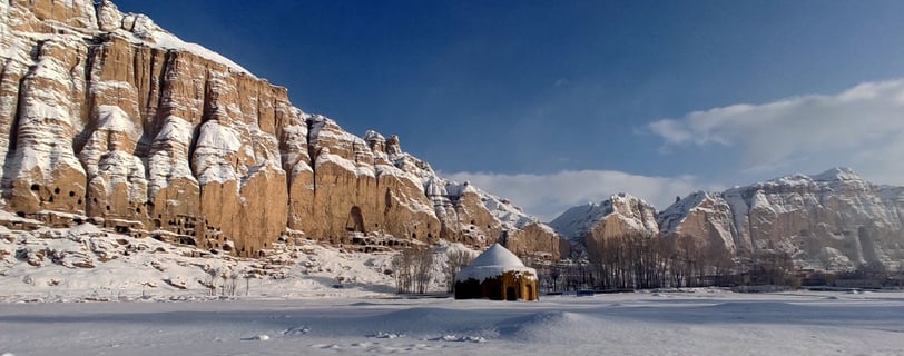 Bamiyan snowy winter landscape with an Muslim tomb and the Buddha niche in the background