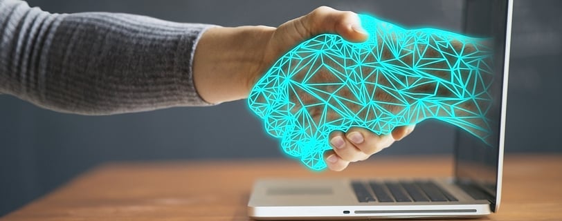 Human and AI shaking hands