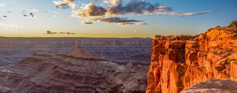 a person standing on a cliff overlooking a canyon