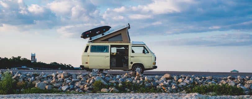 white van under cloudy sky during daytime