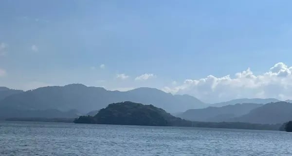 a boat is sailing on Lago de Yojoa Honduras