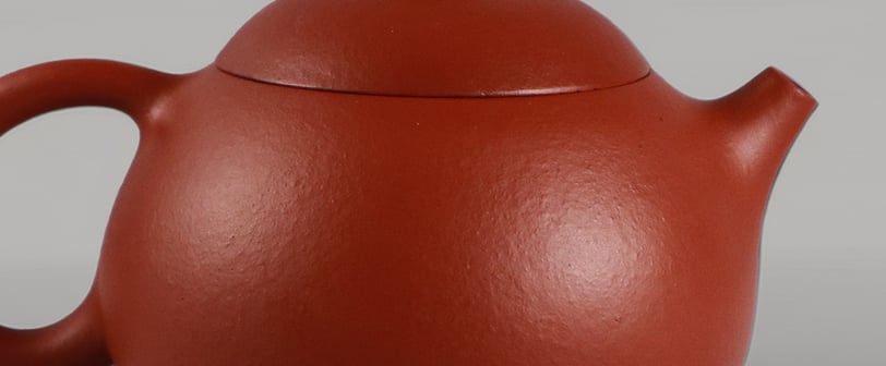 Tiny spots scattered across the teapot visible under bright light