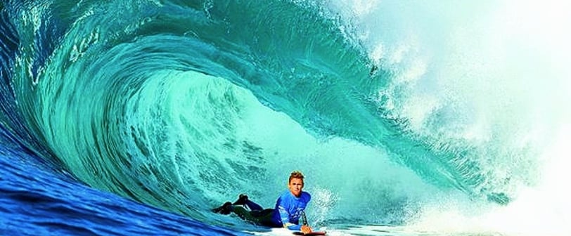 Bodyboarder riding a wave, inspired by Tom Morey’s Boogie Board legacy on Bodyboardingart.com