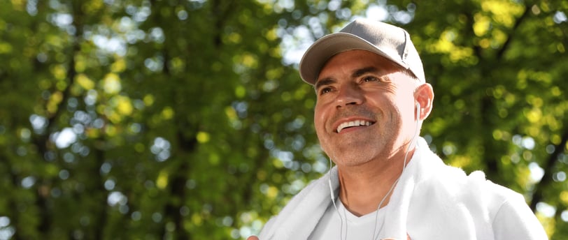 A middle-aged man smiling outdoors after a workout, emphasising fitness and metabolic health.