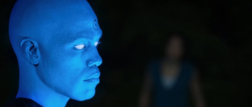 a man with blue eyes and a blue glow